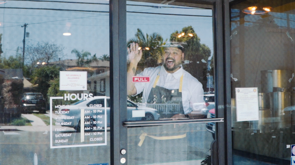 Chef AC Boral in the window of what will become his first brick and mortar restaurant. Photo courtesy AC Boral.