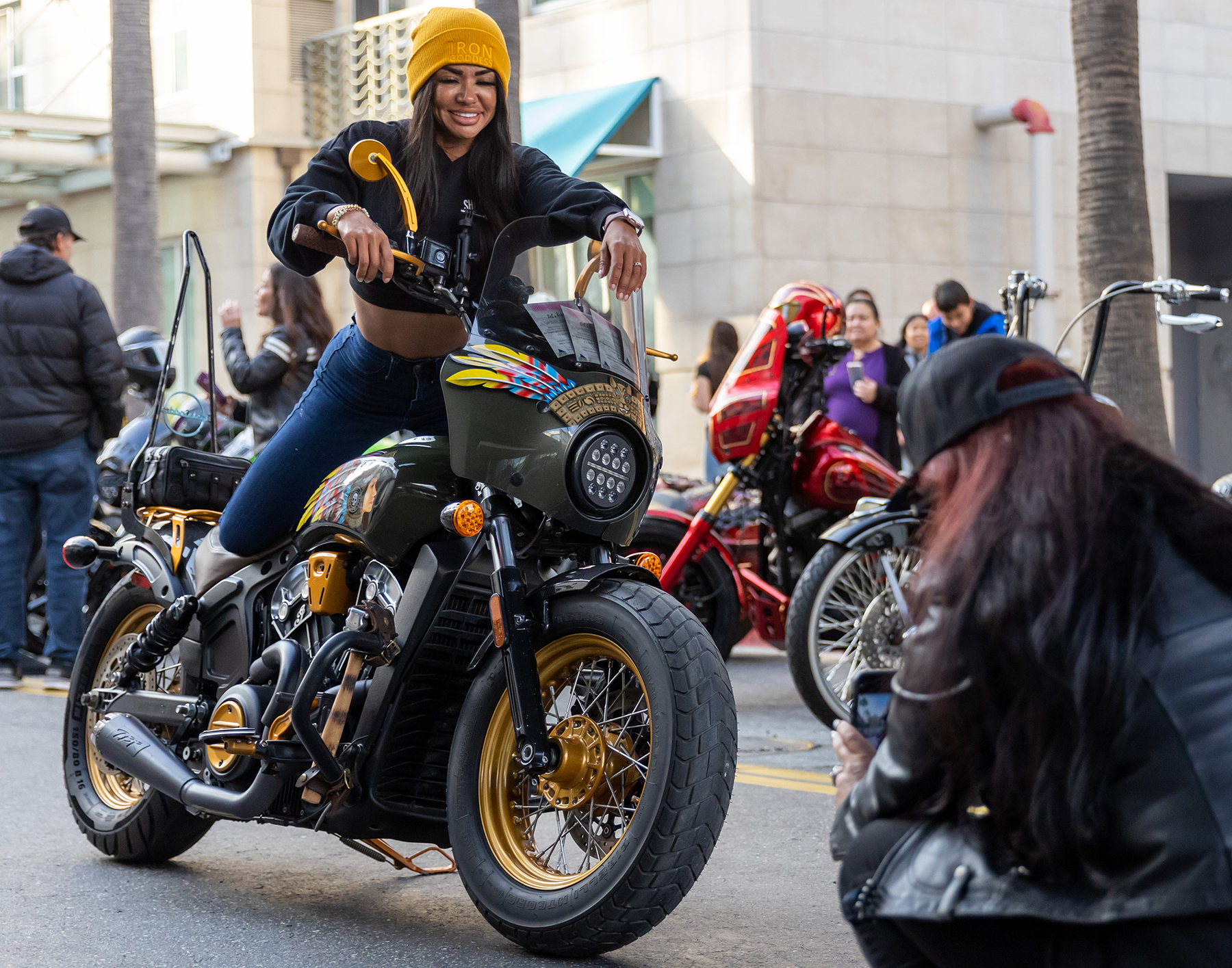 Bunnie Geer of the Iron Goddess Motorcycle Show poses for photos on her motorcycle during Thunder Thursday at the Pike Outlets.