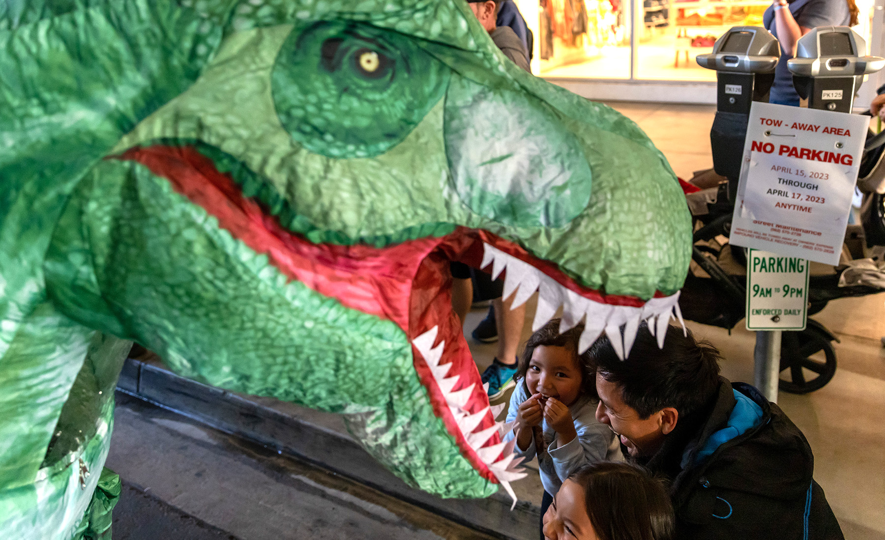 Moeko Zapata, 4, and family play along with Porsche’s “GT3Rawr” race car dinosaur during Thunder Thursday at the Pike Outlets.