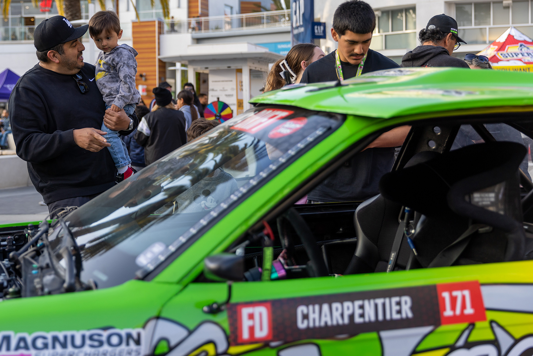 Families take a look inside Rome Charpentier’s Formula Drift car during Thunder Thursday at the Pike Outlets.