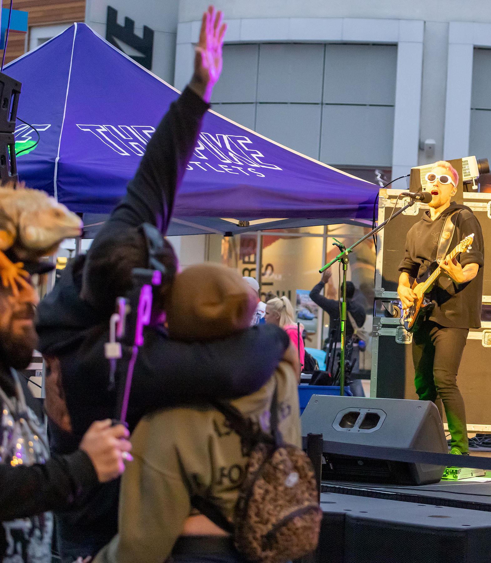 Attendees sing along and cheer during the Brobots performance at the Pike Outlets.