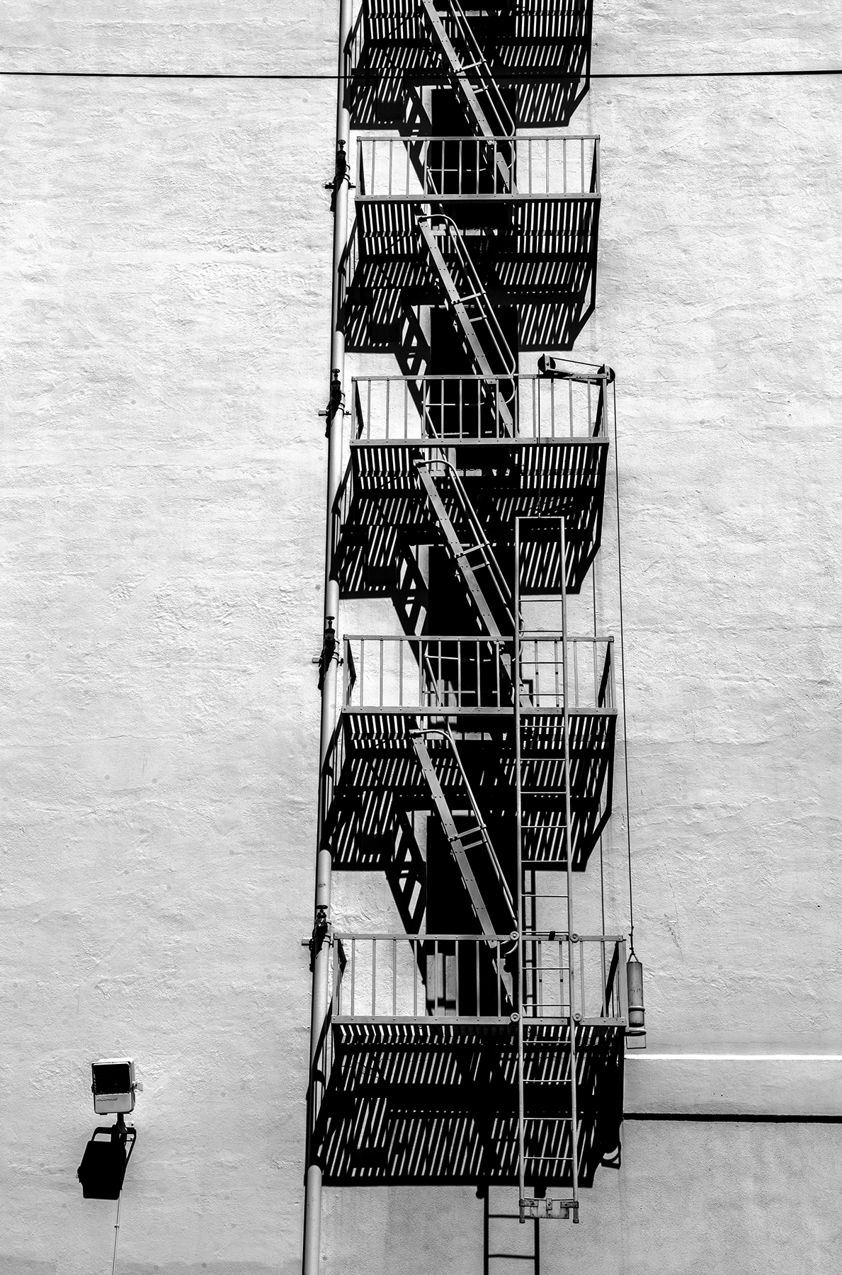 Highlights and shadows outline a fire escape.