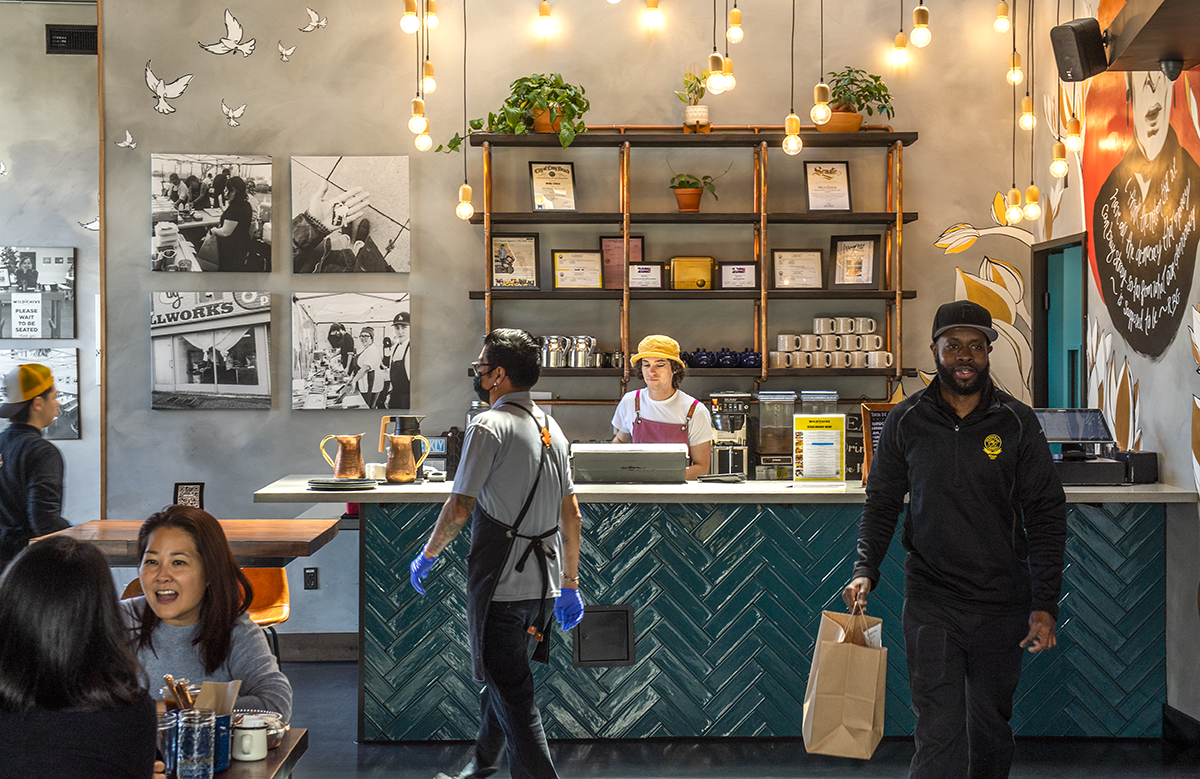 Patrons and Wild Chive staff move and dine within the restaurant.