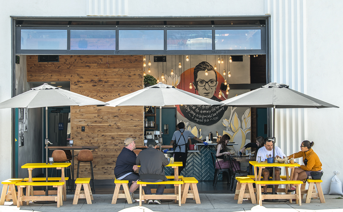 Dinners are set outside next to a roll-up door to access to the restaurant