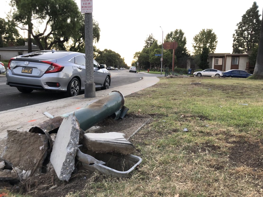 The wreckage after an SUV jumped a curb and hit two adults and a child walking along Los Cerritos Park. Photo by Jeremiah Dobruck.