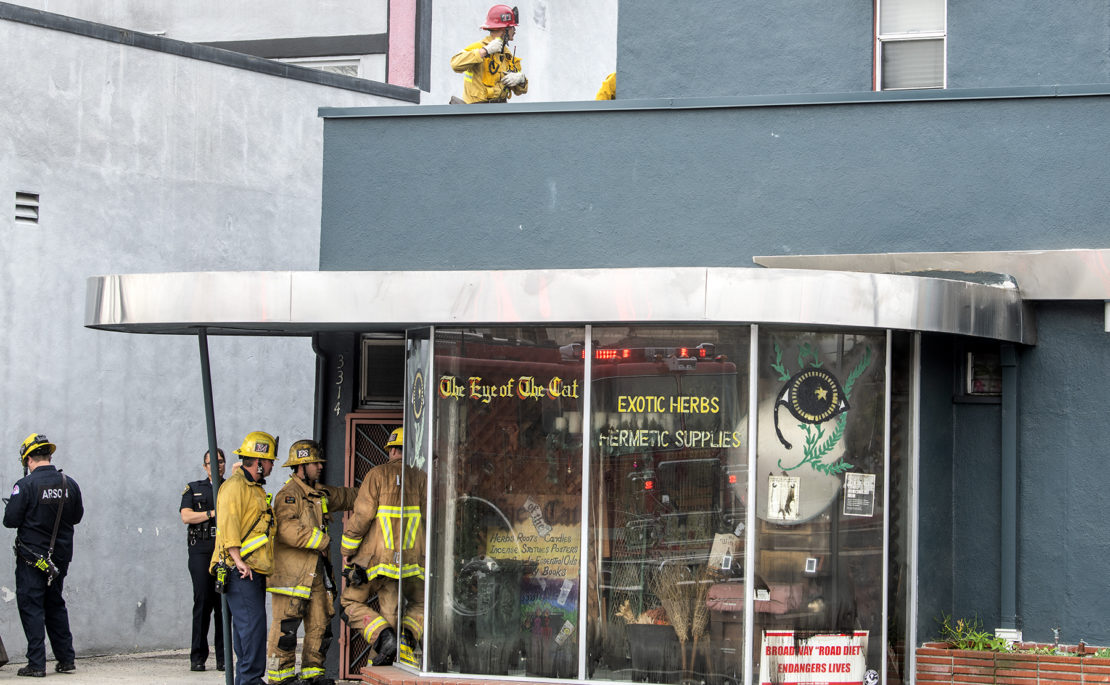 Long Beach firefighters mopping up after a blaze charred the inside of Eye of the Cat on Monday, March 9, 2020. Photo by Thomas R. Cordova.