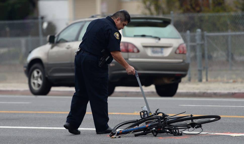 A Long Beach Police officer at the scene of a fatal car accident involving a bicyclist, at the corner of Los Coyotes Diagonal and Palos Verdes Avenue, Wednesday January 30th, 2019. Photo by Stephen Carr / For the Long Beach Post