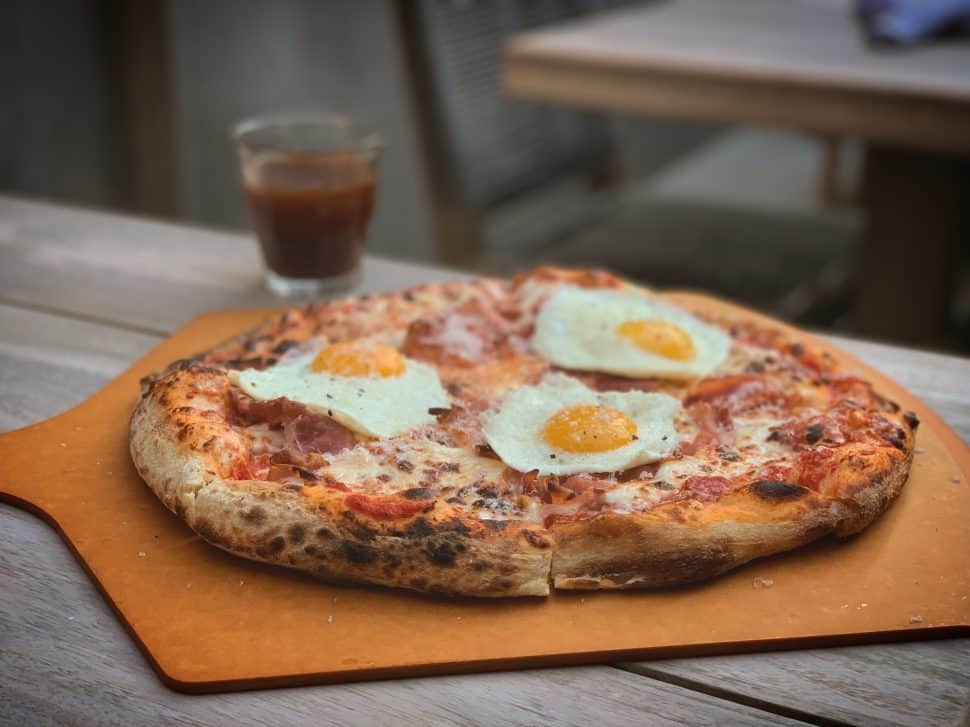 Vibes' Breakfast Pizza, topped with prosciutto and eggs. Photo by Brian Addison.