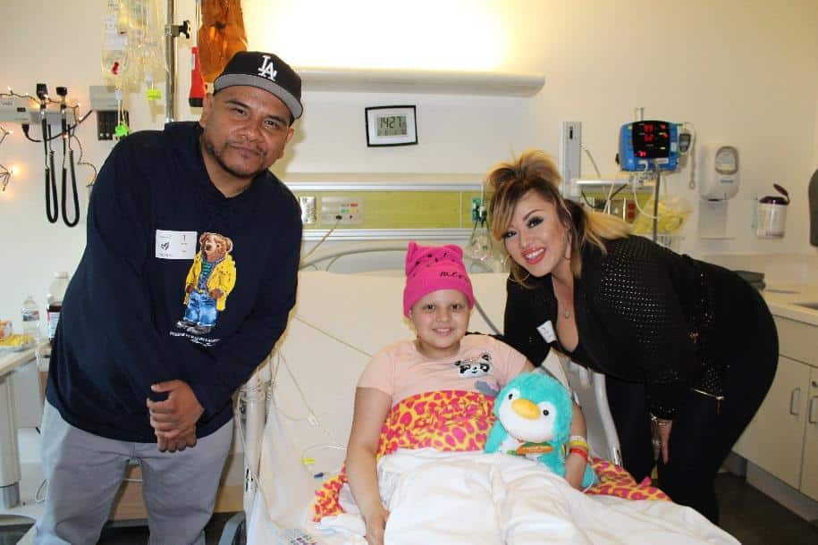 Power 106’s, DJs J Cruz and Cece Valencia visit Kayla, 10, at her bedside
to surprise her with a stuffed animal.