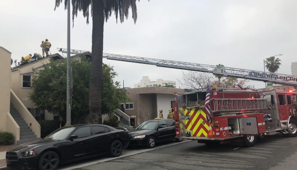 Firefighters were still working on the roof of a building on Pacific Avenue where a blaze broke out Thursday, April 25, 2018. Photo by Jeremiah Dobruck.