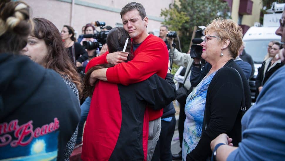 James Ridgers embraces a friend as he attends a candlelight vigil for his friend Jessica Bingman, 41, and the 5 dogs that died in a car accident at Bluff Heights in Long Beach Wednesday, May 08, 2019. Tuesday morning a driver who’d been fleeing from police crashed, killing Bingman and the five dogs in the car he hit. Photo by Thomas R. Cordova.